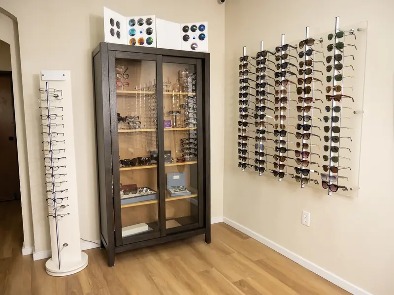 Eyewear display cabinet and sunglasses wall in the Kingsley Optical showroom